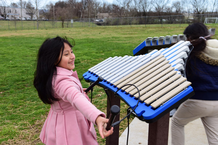 young girls playing with duet instrument