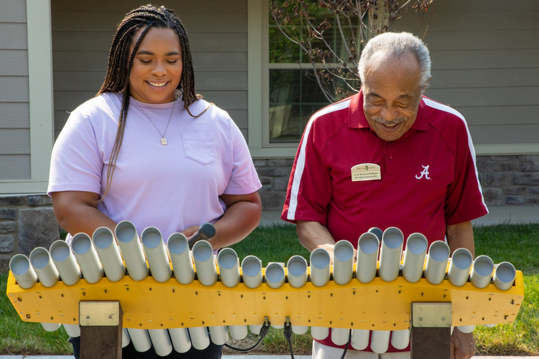 daughter and father playing the Imbarimba instrument