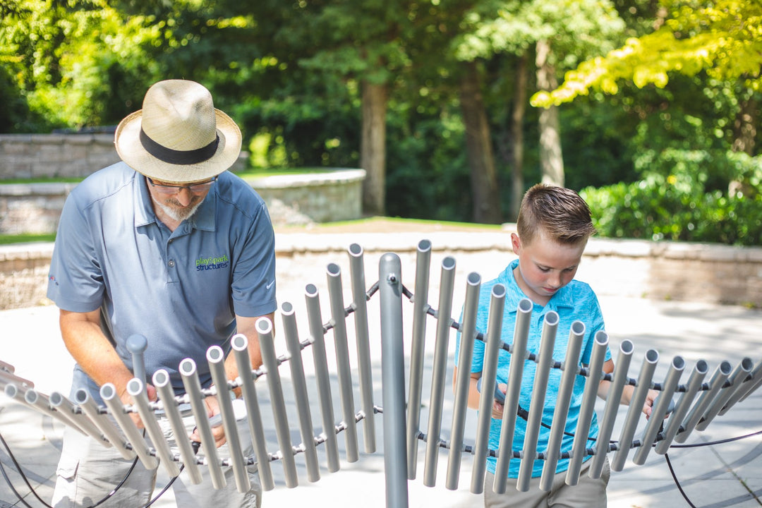 grandfather and son playing the mantra ray instrument