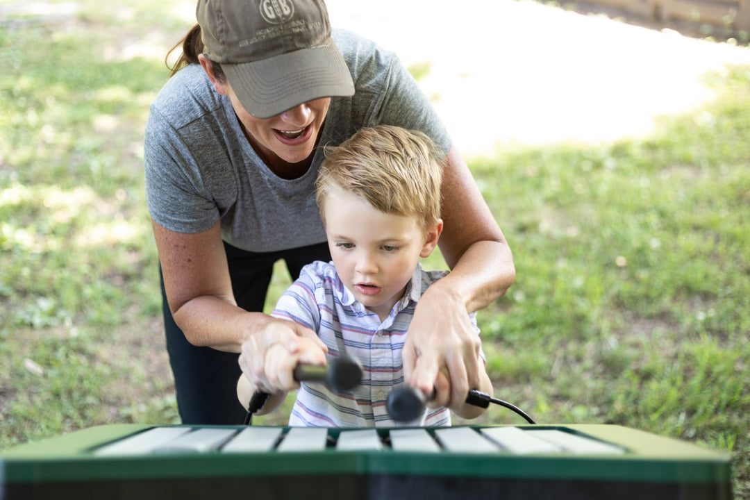 a mom and her son playing the melody instrument